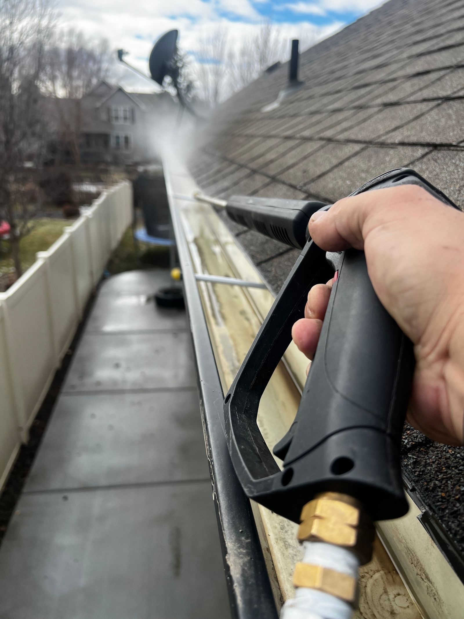Residential gutter being cleaned